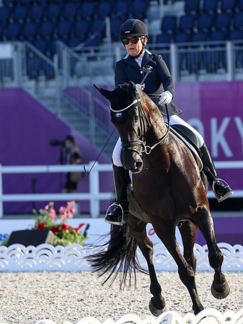 A female athlete rides a horse at Tokyo 2020